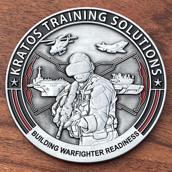 Round silver 3D challenge coin for Kratos Training Solutions. 