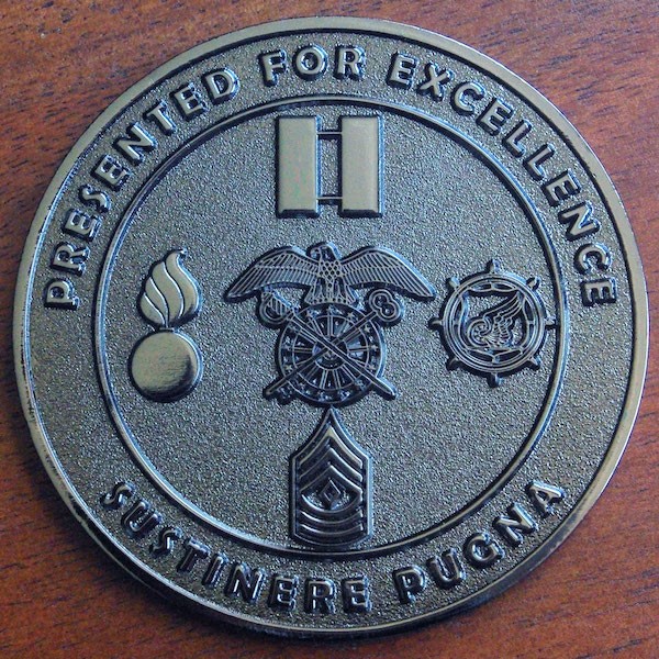Round black nickel military challenge coin. 