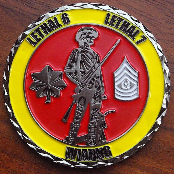 A round black nickel challenge coin for the Wisconsin Army National Guard. 