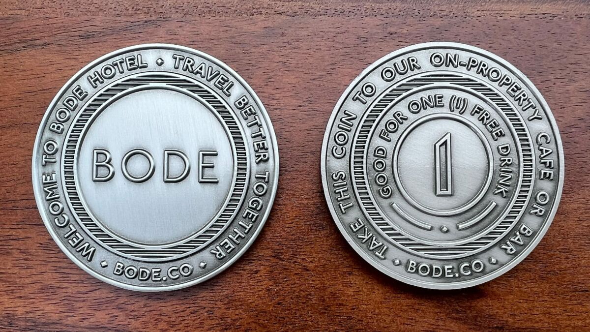 Round challenge coin representing Bode Hotels, both obverse and reverse