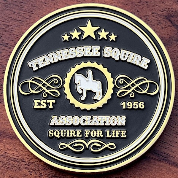 Polished gold challenge coin belonging to Tennessee Squire Association, marketing program of Jack Daniel's