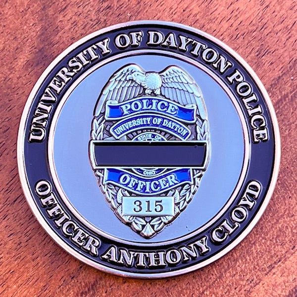 Silver challenge coin representing the University of Dayton Police Department and honoring Officer Anthony Cloyd.  
