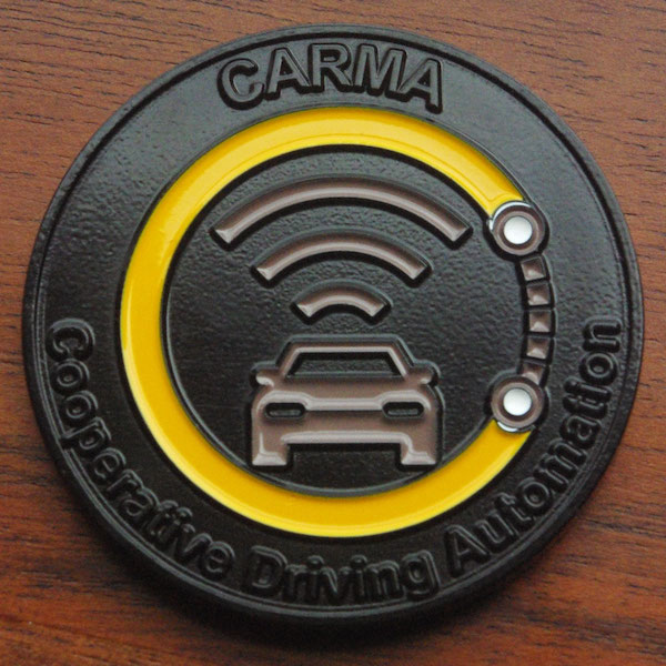 Round dyed metal challenge coin representing Carma. 
