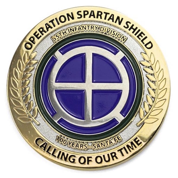 Round polished gold challenge coin representing the Army's 35th Infantry Division.