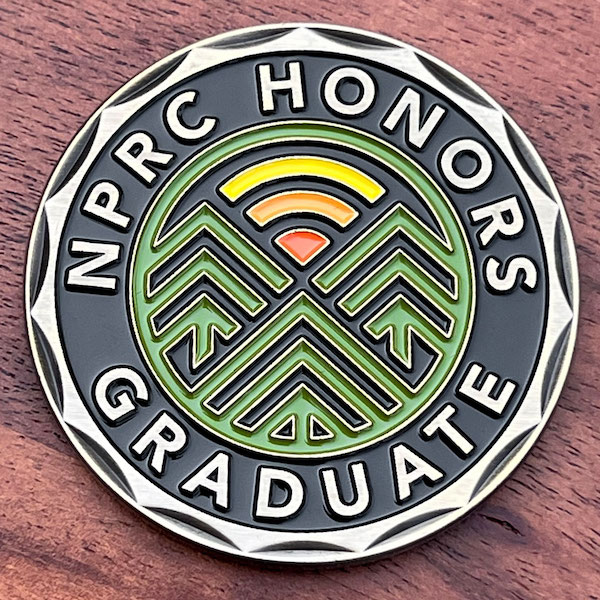 Round polished silver challenge coin for Northern Pennsylvania Regional College. 