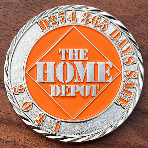 Round polished silver challenge coin representing Home Depot