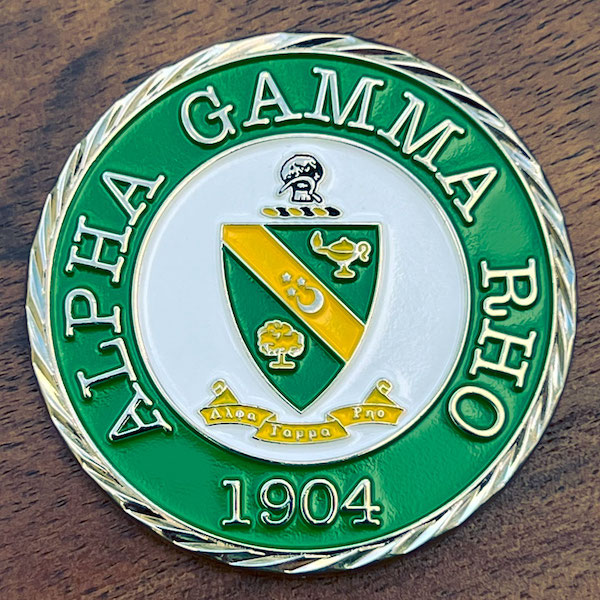Round polished silver challenge coin commemorating Alpha Gamma Rho. 