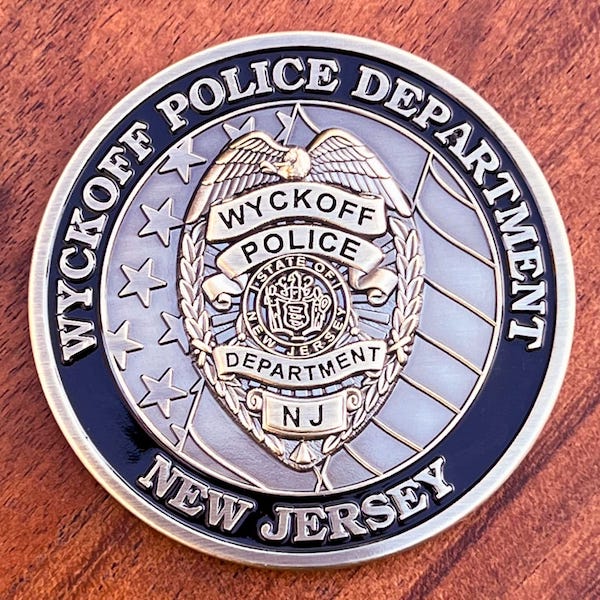 Round silver challenge coin for the Wyckoff, New Jersey police department.