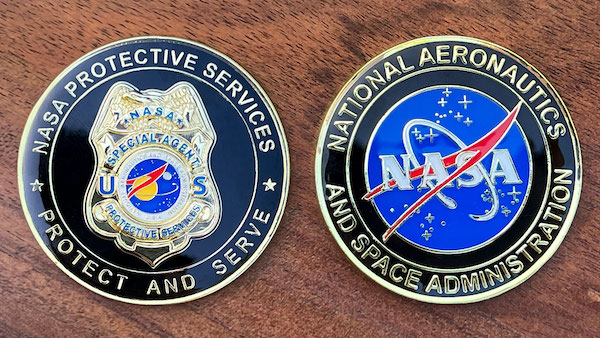 Round challenge coin representing NASA Protective Services. 