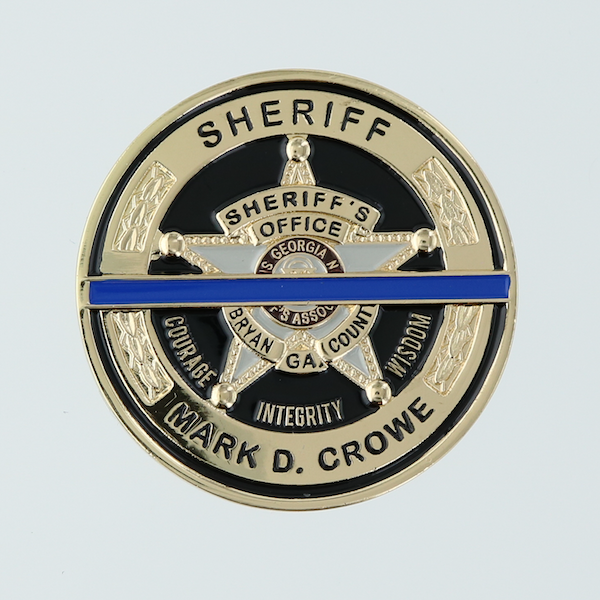 Round custom coin with sheriff's star in center. Black and gold, with a blue line running through the center.