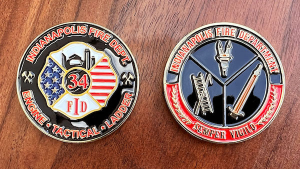 Round silver challenge coin representing the Indianapolis Fire Department. 