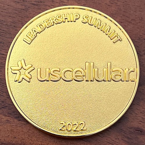 Polished gold challenge coin belonging to US Cellular. 