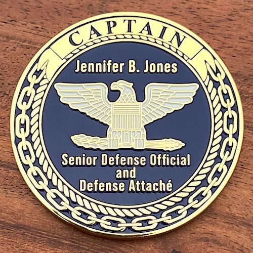 Polished gold military challenge coin for Senior Defense Official and Defense Attache, Jennifer B. Jones. 