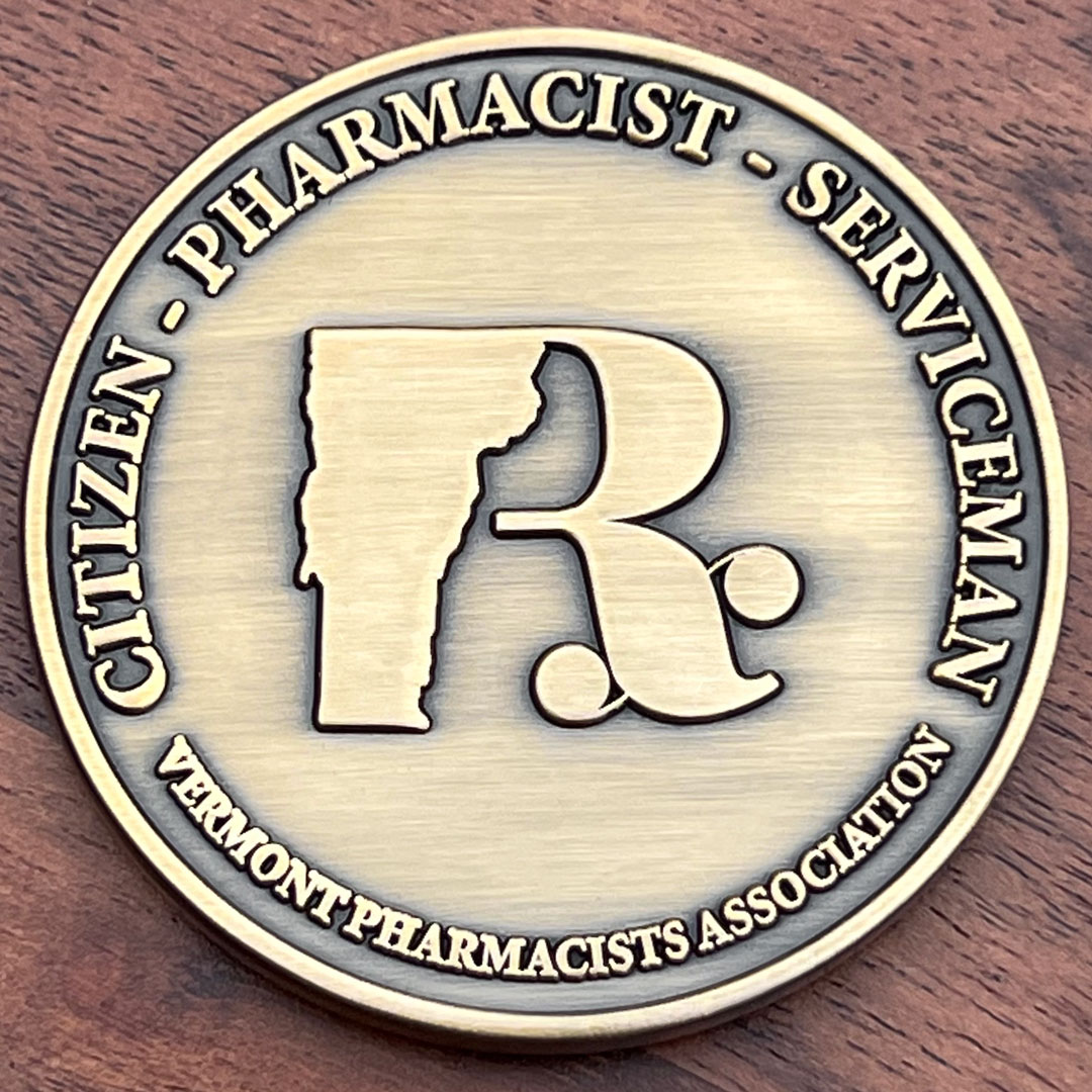 Round gold challenge coin representing the Vermont Pharmacists Association. 