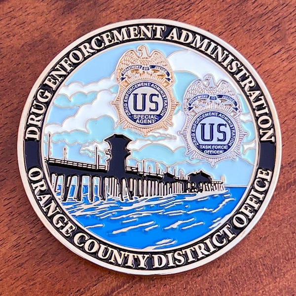 Round silver challenge coin representing the DEA Orange County, California District 