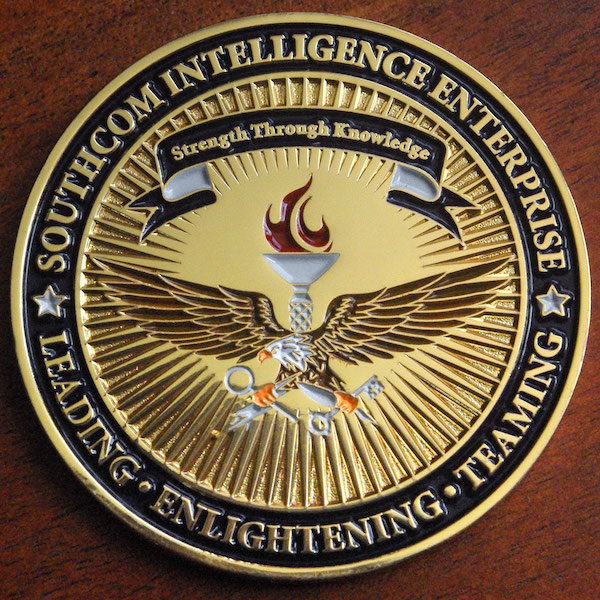 A round antique gold challenge coin for Southcom Intelligence Enterprise. 