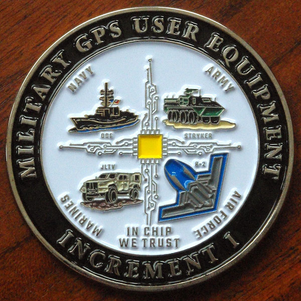 A round challenge coin for military GPS user equipment. 