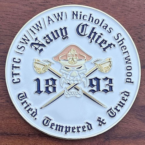 White coin with polished gold base honoring Navy Chief Nicholas Sherwood