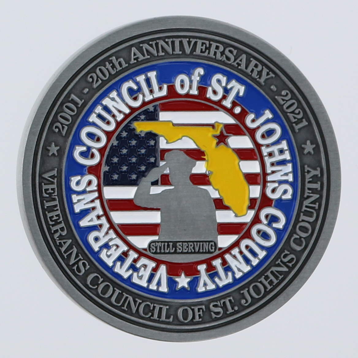 Reverse side of a round challenge coin belonging to the Veterans Council of St. Johns County in St. Augustine, Florida. 