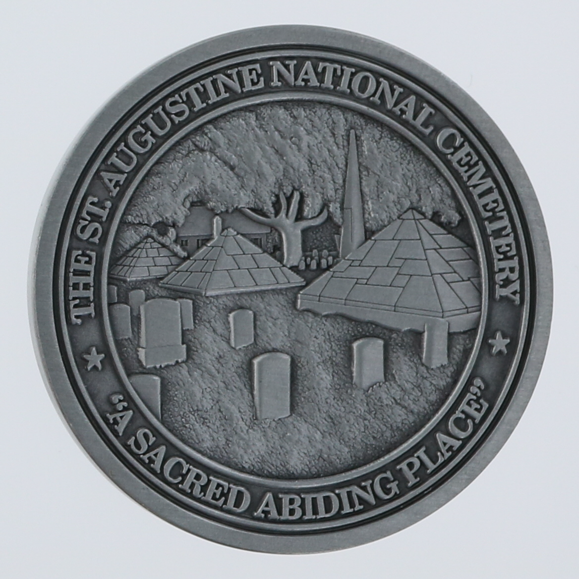 Front side of a round challenge coin belonging to the Veterans Council of St. Johns County in St. Augustine, Florida. 