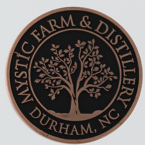 Reverse side of a round challenge coin for Mystic Farm and Distillery to celebrate Broken Oak whiskey. 