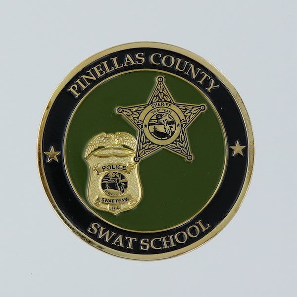 Front side of a round challenge coin belonging to the Pinellas County SWAT School. 