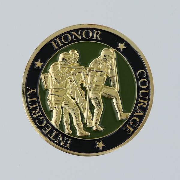 Reverse side of a round challenge coin belonging to the Pinellas County SWAT School. 