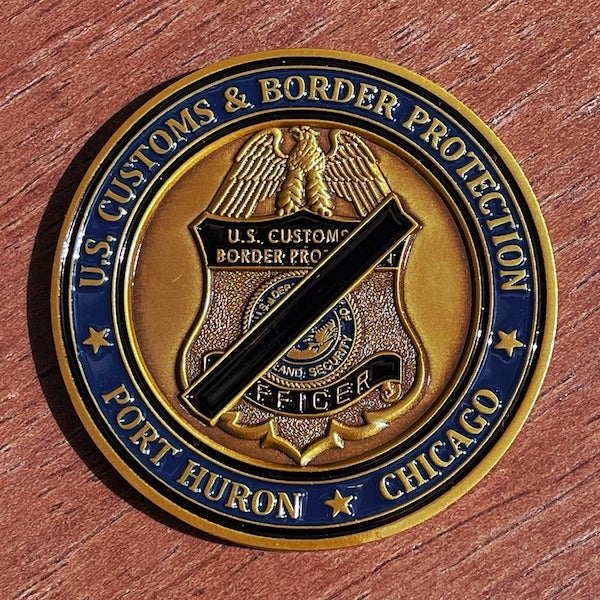 Round challenge coin belonging to U.S. Customs and Border Protection in Port Huron and Chicago. 