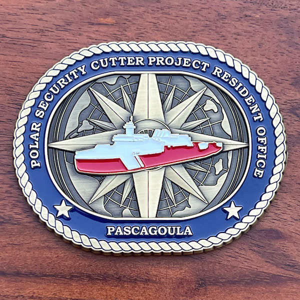 An oval challenge coin representing the Polar Security Cutter Project Resident Office 