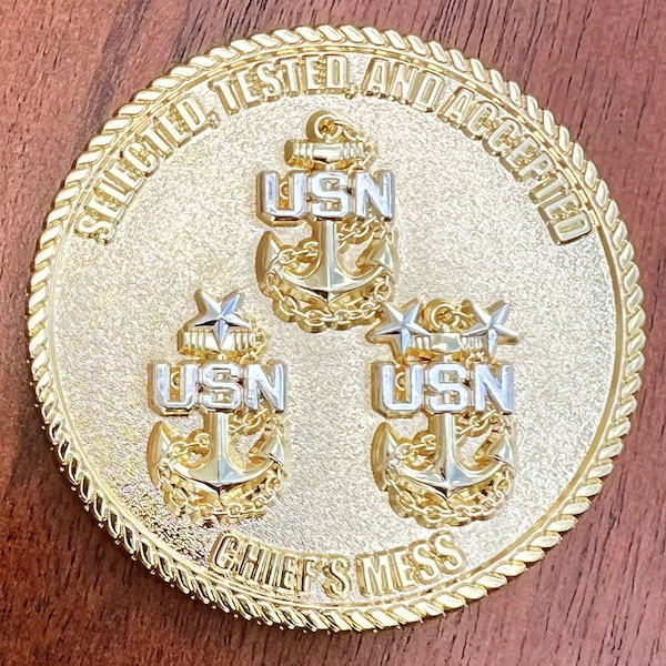 A round polished gold challenge coin representing U.S. Navy Chief Petty Officers