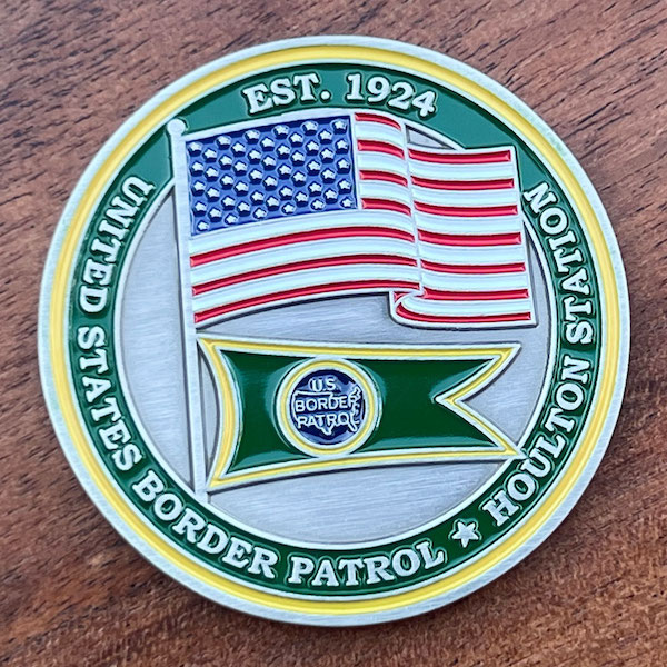 Round silver challenge coin representing the U.S. Border Patrol’s Houlton (Maine) Station.