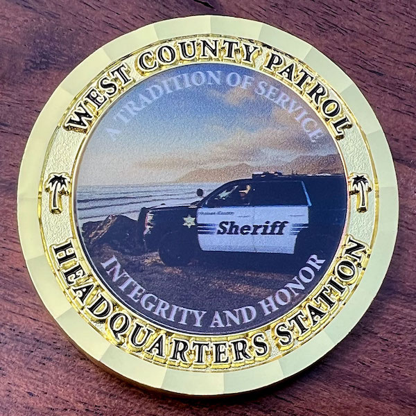 Round gold challenge coin belonging to the West County Patrol in Ventura, California. 