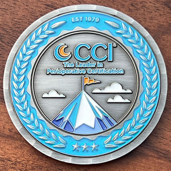 Round silver challenge coin for CCI (Competency and Credentialing Institute). 
