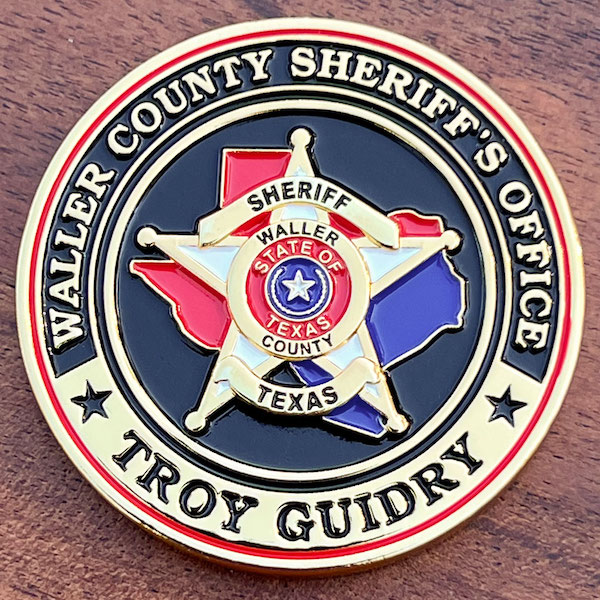 Polished gold challenge coin representing the Waller County Texas Sheriff's Office and Sheriff Troy Guidry.