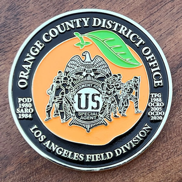 Round silver challenge coin belonging to the US Drug Enforcement Administration Los Angeles Field Division. 